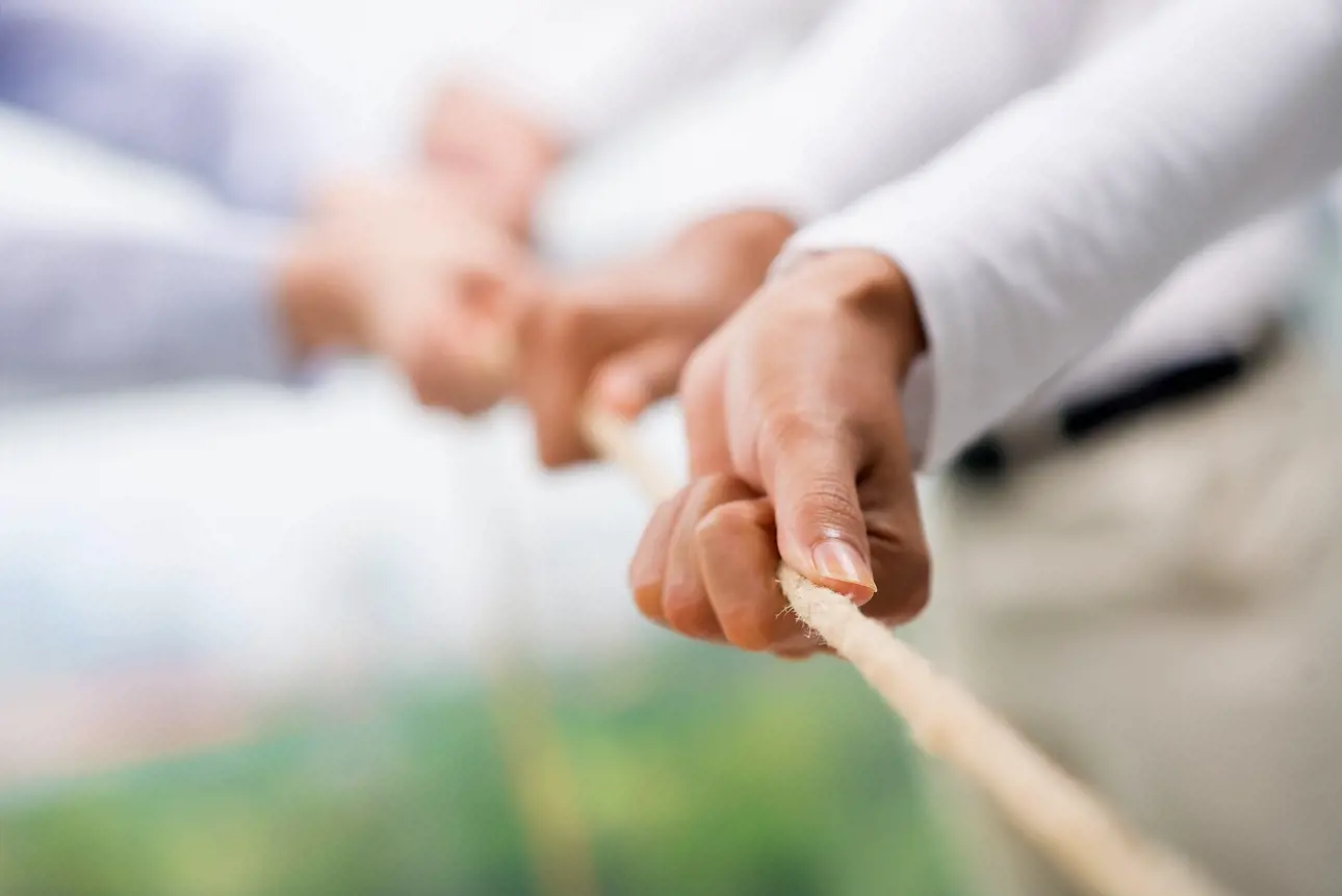 Hands pulling a rope