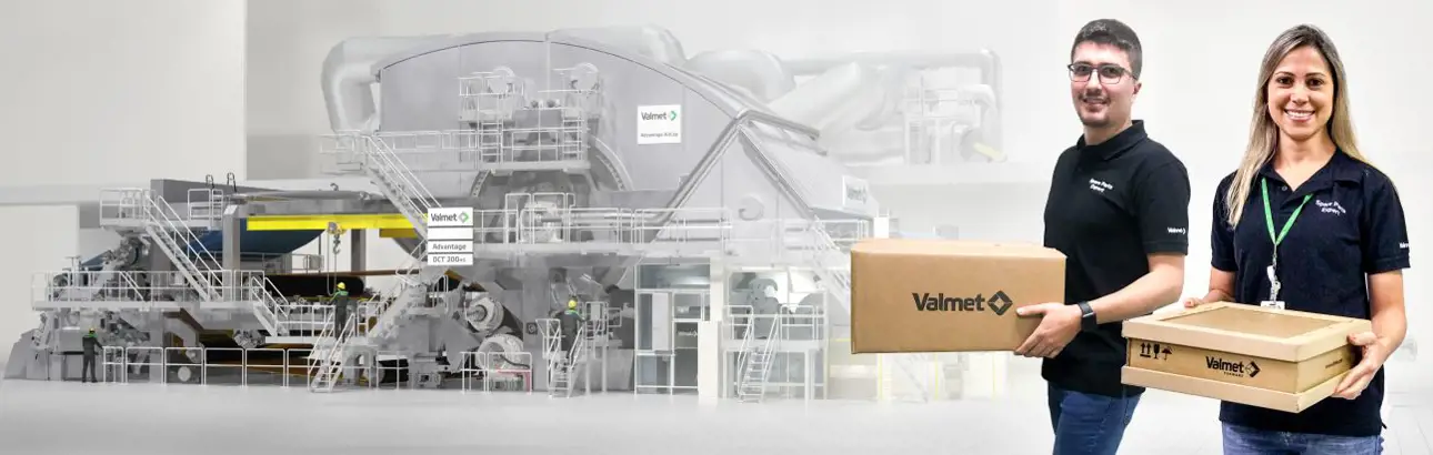 Two smiling Valmet employees holding delivery boxes labeled with the Valmet logo, standing in front of a digitally rendered tissue machine.
